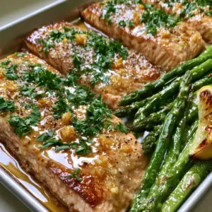 Extreme close-up of Garlic butter baked salmon with golden minced garlic and fresh parsley garnish.