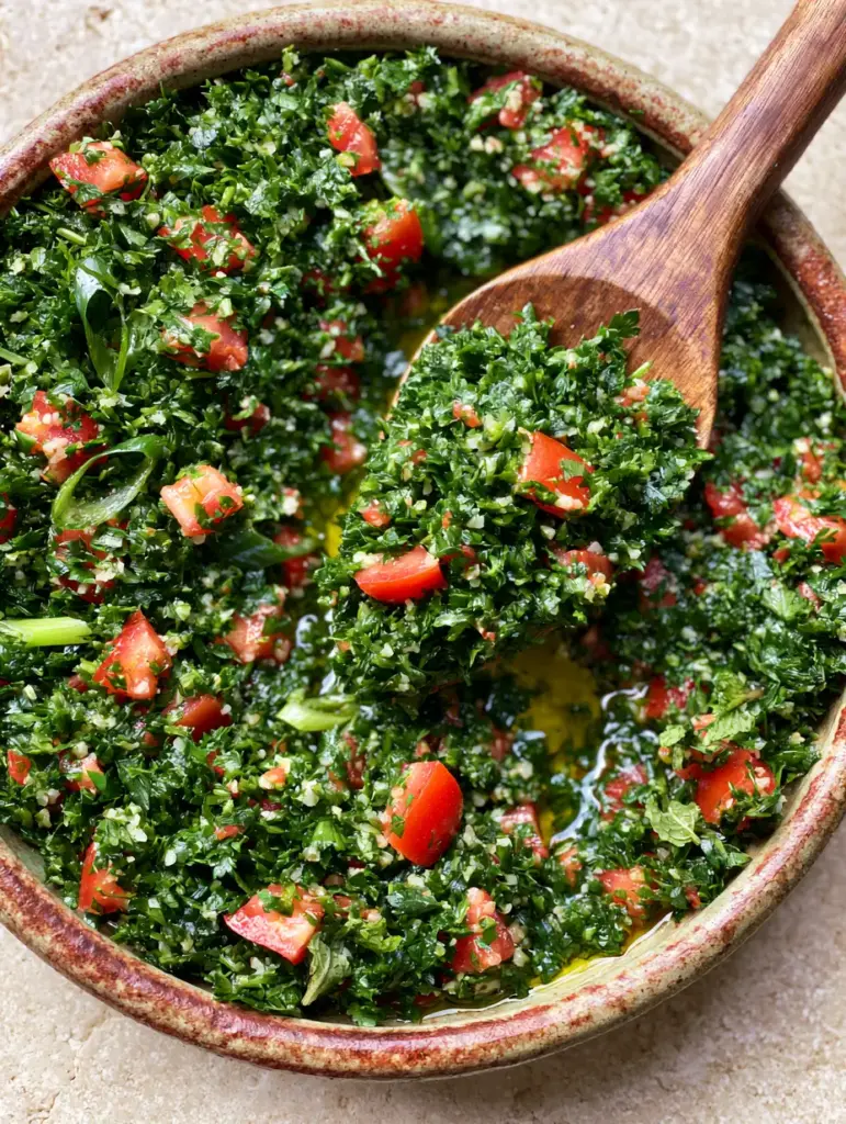 Lebanese Tabbouleh Recipe: The Ultimate Guide to Authentic, Fluffy Emerald Salad 1 Close-up of microscopic bulgur wheat and tiny tomato cubes in a Lebanese tabbouleh recipe.