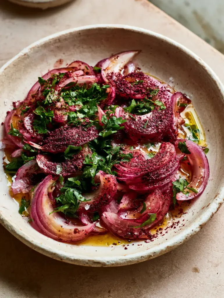 Turkish Onion Salad (Sumac Onions): The Ultimate Vibrant Side Dish 2 Close up of translucent red onion crescents dusted with dark burgundy sumac spice for Turkish onion salad.