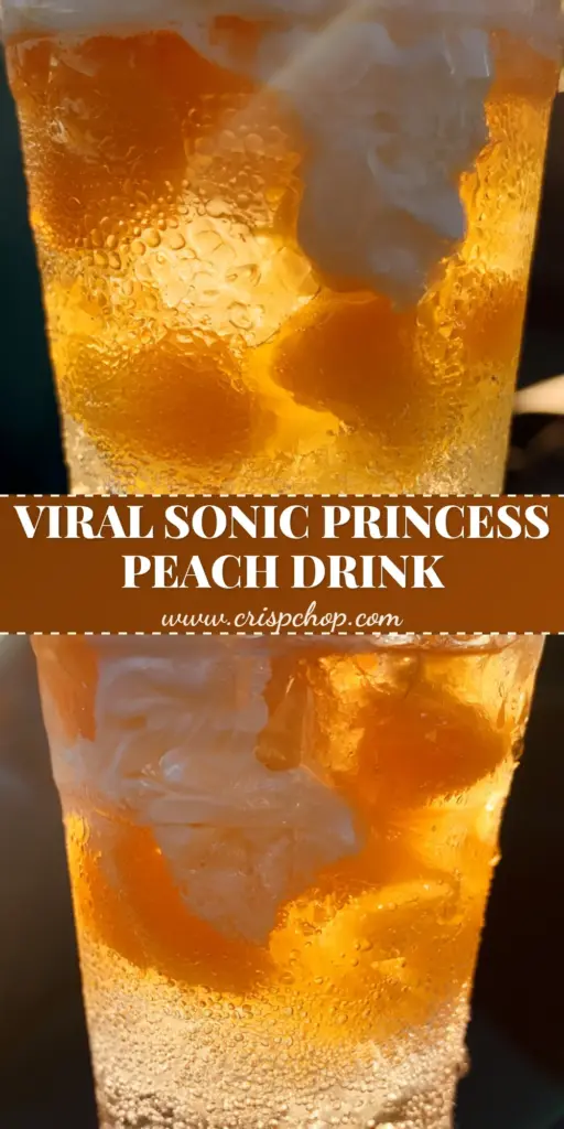 A tall clear plastic cup holding the Sonic Princess Peach Drink with pink and gold ombre layers, sweet cream cloud, and pebble ice in a car cup holder. (Sonic Princess Peach Drink)