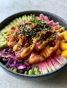 Close up of succulent cubes of glazed ahi tuna and salmon with pearlescent rice. (poke bowl ideas)