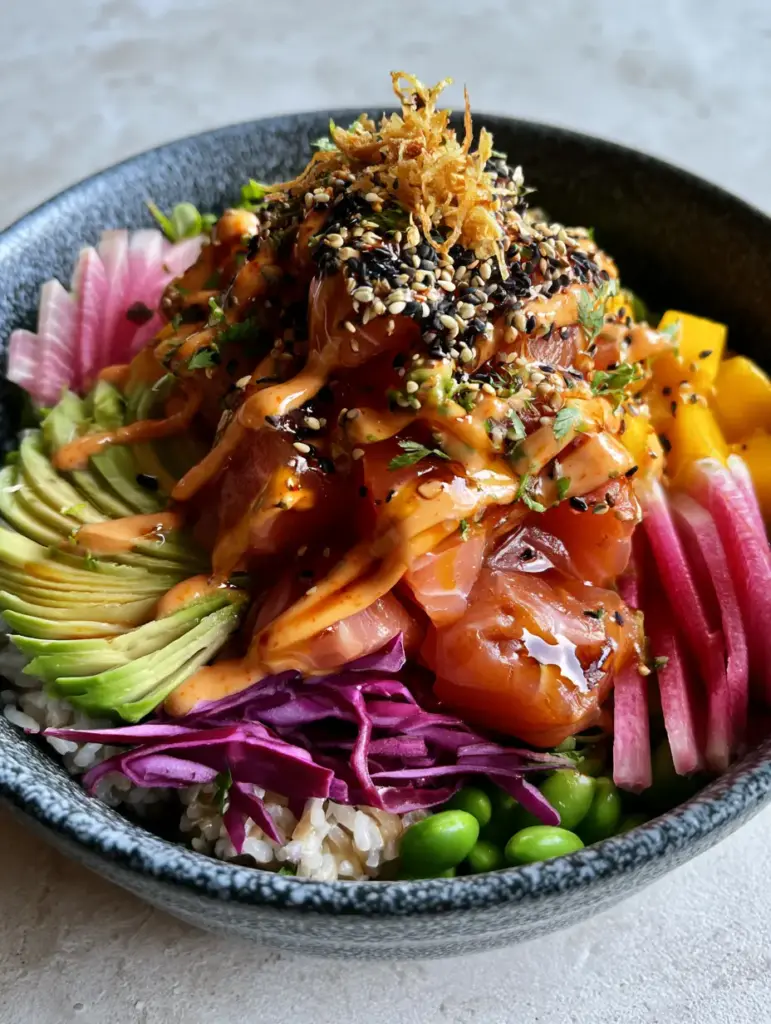 Poke Bowl Ideas: The Ultimate Glazed Ahi Tuna and Salmon Masterpiece 1 A fully assembled poke bowl with sriracha mayo drizzle and crispy fried onions.