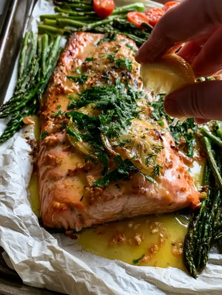Lemon Herb Butter Trout with Blistered Asparagus and Roasted Tomatoes 2 Succulent sheet pan lemon herb butter trout with golden-brown edges and a thick garlic butter sauce.